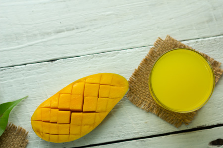 mango on a white wood background. tinting. selective focus on the mangos slices.の写真素材