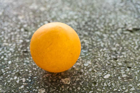 Orange table tennis ball on the floor.の写真素材