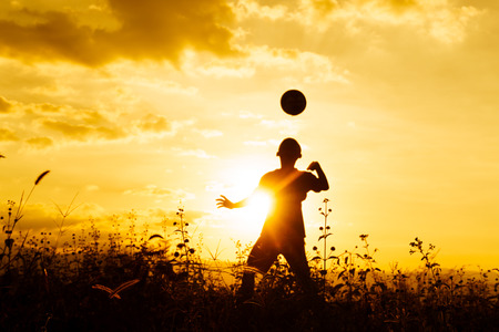 Shadows play football at sunset,Yellow tone.の写真素材