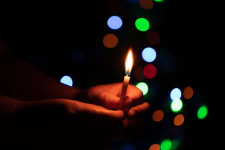 The hand that protects the candles in the dark.の写真素材