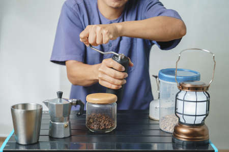 Asian boy learning to make coffee with moka pot.の写真素材