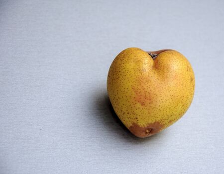 Pear shaped heart. Background unusual fruitの写真素材