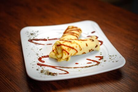 Delicious pancakes with meat, spices and sauce on a white plateの写真素材
