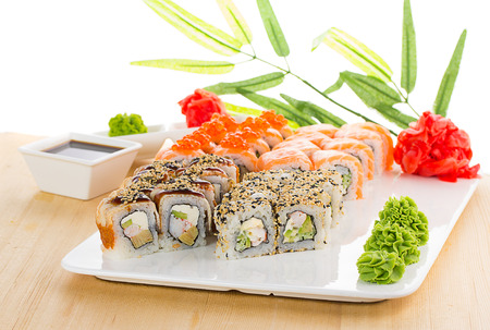 Sushi set on white plate over wooden backgroundの写真素材