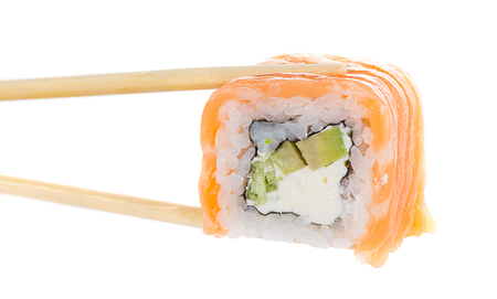 Sushi roll with chopsticks isolated on whiteの写真素材