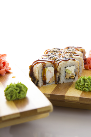 sushi on a wooden plate gete isolated on white backgroundの写真素材