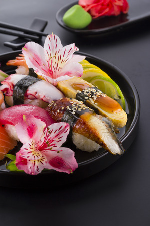 Sushi set on a black plate and black backgroundの写真素材