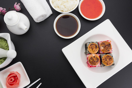 Sushi roll with fresh ingredients with ginger wasabi over black backgroundの写真素材