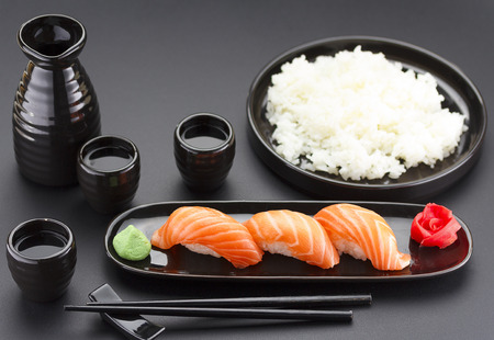 Japanese cuisine. Sushi roll with soy sauce over black background.の写真素材