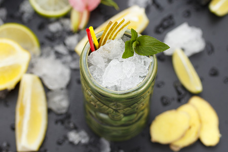 Tropical cocktails served in a tiki style glass and garnished with fruits and iceの写真素材