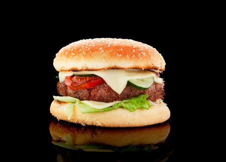 Big burger over black background.の写真素材