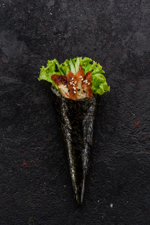 Eel handmade sushi (temaki) on a stone plate.の写真素材