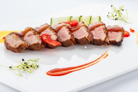 Duck meat on a white plate.の写真素材