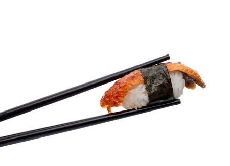 Japanese cuisine. Sushi nigiri in chopsticks isolated on white background background.の写真素材