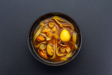 Asian soup over dark background.の写真素材