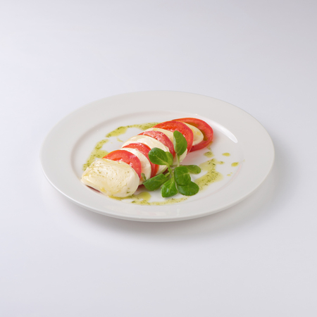 Fried tomatoes with parmesan isolated on white backgroundの写真素材