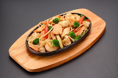 Thai dish. Udon noodles with vegetables and salmon.の写真素材