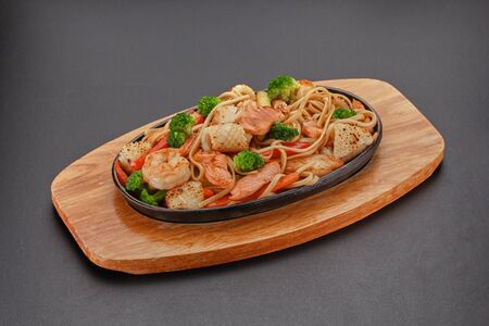 Thai dish. Udon noodles with vegetables and salmon.の写真素材