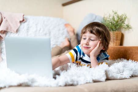 Back to school. Distance learning online education. Caucasian smile preschooler kid boy studying at...