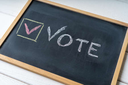 Vote Written On Blackboard. The concept of making choices. Presidential and parliamentary elections. Calling for voting, democracy.の写真素材