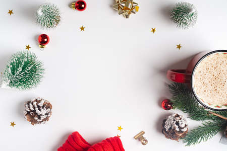 Flat lay of white working table background with Christmas decoration. Top view balls, fir tree,...