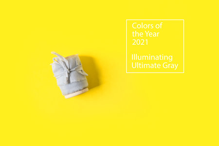 Flat lay with gray tape on trendy yellow background with copy space. Illuminating Yellow and Ultimate Gray, new colors of the year 2021.の写真素材