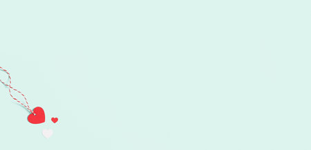 Background with red and white hearts label with free space for text on pastel blue background. Valentines day concept. Mothers Day concept. Greetings. Copy space. Flat lay, top view.の写真素材