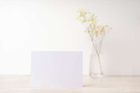 White blank letter greeting card, mockup on white background. Romantic love letter, invitation with flowers, copy space for textの写真素材
