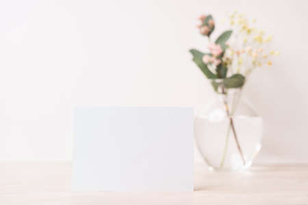 White blank letter greeting card, mockup on white background. Romantic love letter, invitation with flowers, copy space for textの写真素材