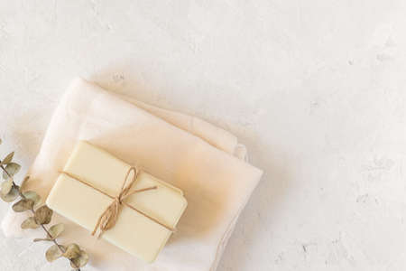 Wooden soap dish, craft paper, cotton fabric, soap, over white background. Zero waste, natural organic bathroom tools. Plastic free life. Ecological skin care, body treatment conceptの写真素材