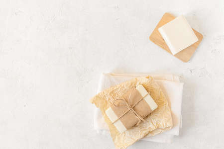 Wooden soap dish, craft paper, cotton fabric, soap, over white background. Zero waste, natural organic bathroom tools. Plastic free life. Ecological skin care, body treatment conceptの写真素材