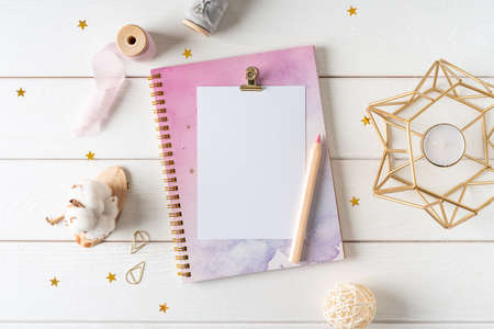 Top view of white working table background with blank paper notebook, nature cotton. Flat lay still...