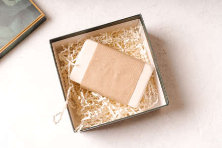 Soap in Craft eco Gift box or present box on white background with mockup blank paper package. Copy...
