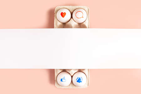 Colorful funny face made of easter eggs on pink background with copy space for text and mock up for...