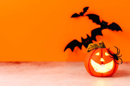 Happy halloween holiday concept. Jack o lantern, handmade paper decorations, spiders, ghosts, bats, boo text on orange background. Halloween festival party, greeting card mockup with copy space.の写真素材