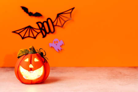 Happy halloween holiday concept. Jack o lantern, handmade paper decorations, spiders, ghosts, bats, boo text on orange background. Halloween festival party, greeting card mockup with copy space.の写真素材