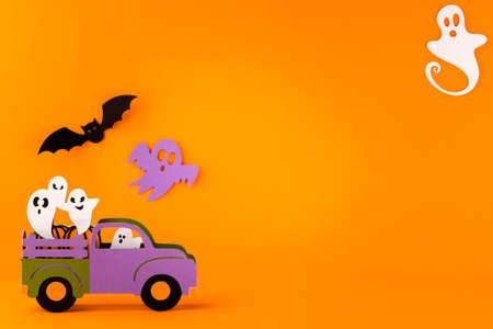 Happy halloween holiday concept. Halloween handmade paper decorations, spiders, ghosts in car on...