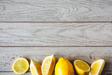 Fresh sliced lemon on wooden natural background with space for text. Healthy food concept.の写真素材
