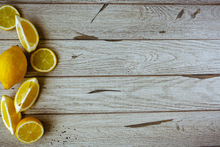 fresh sliced lemon on wooden natural background with space for textの写真素材