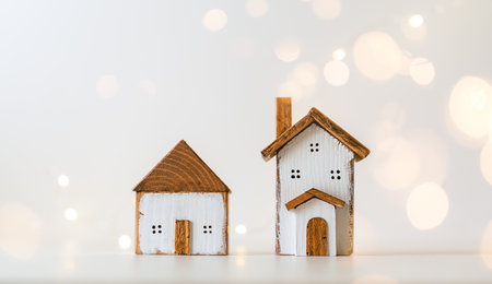 Happy New Year and Merry Christmas postcard. Festive white background with toy wooden house, snow,...