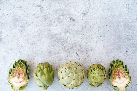 Top view Sliced artichoke on table. Healthy food vegetables on grey background with copy spaceの写真素材