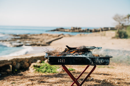 Barbecue grill in nature forest camping park with sea on background.の写真素材