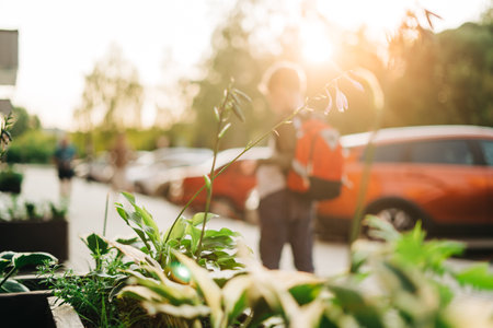 Back to school. Cute child with backpack going to school. Boy pupil with bag. Elementary school student going to classes. Kid walking outdoors on the city street after class. Back viewの写真素材