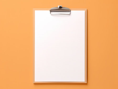 Top view blank paper and clip board. Desktop mock up, Flat lay of orange working table background with office equipment, mockup greeting card.の素材