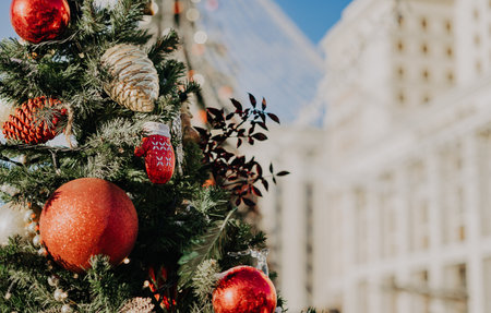 Close up of balls on christmas fir tree. Bokeh light garlands in background with copy space. Merry christmas and happy new yearの写真素材