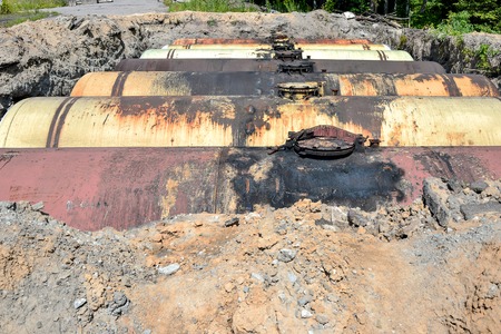 Large metal tanks are buried in the ground in the production warehouse.の写真素材