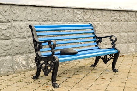 The blue bench in the Park on the tiled pavement. No bodyの写真素材