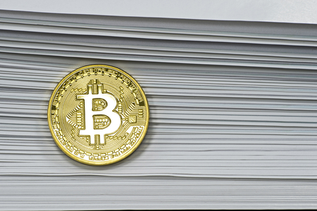 The concept of bitcoin cryptocurrency news, an overview from the pages of Newspapers. The original bitcoin on the background of newspaper pages.の写真素材