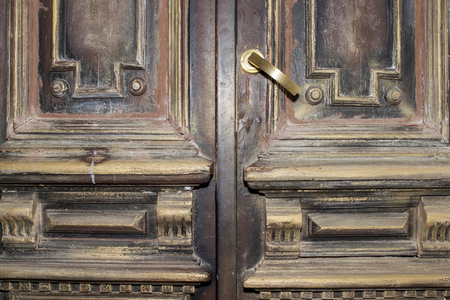 Part of a 17th century wooden door with brass handle. Background.の写真素材