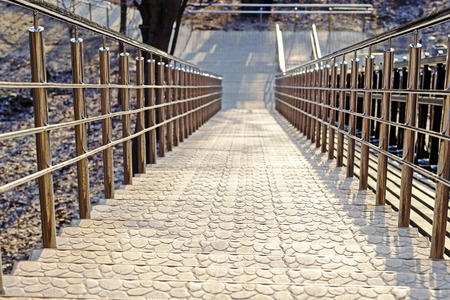 Stairs to the Park with steep steps and shiny metal railings. Top view, background.の写真素材